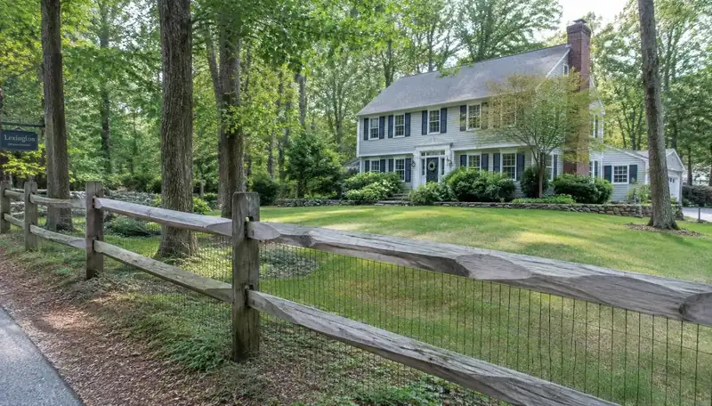 Garden enclosed with split rail and wire mesh in Belmont, MA